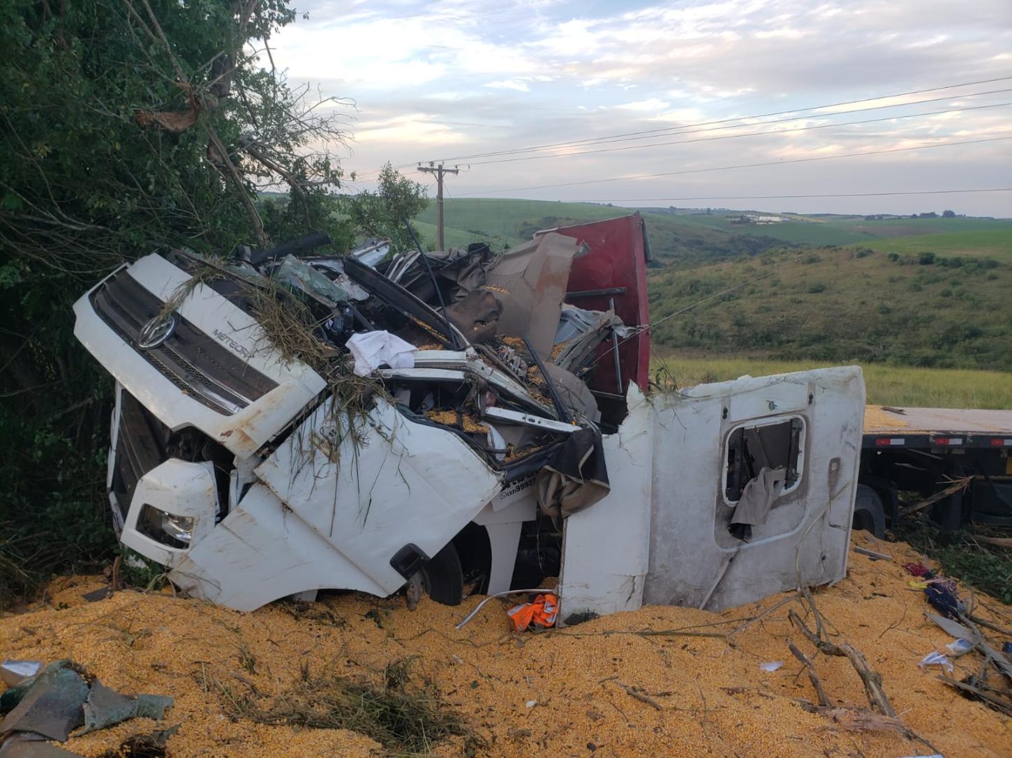 Motorista morre soterrado por carga de milho após carreta capotar na MGC-383